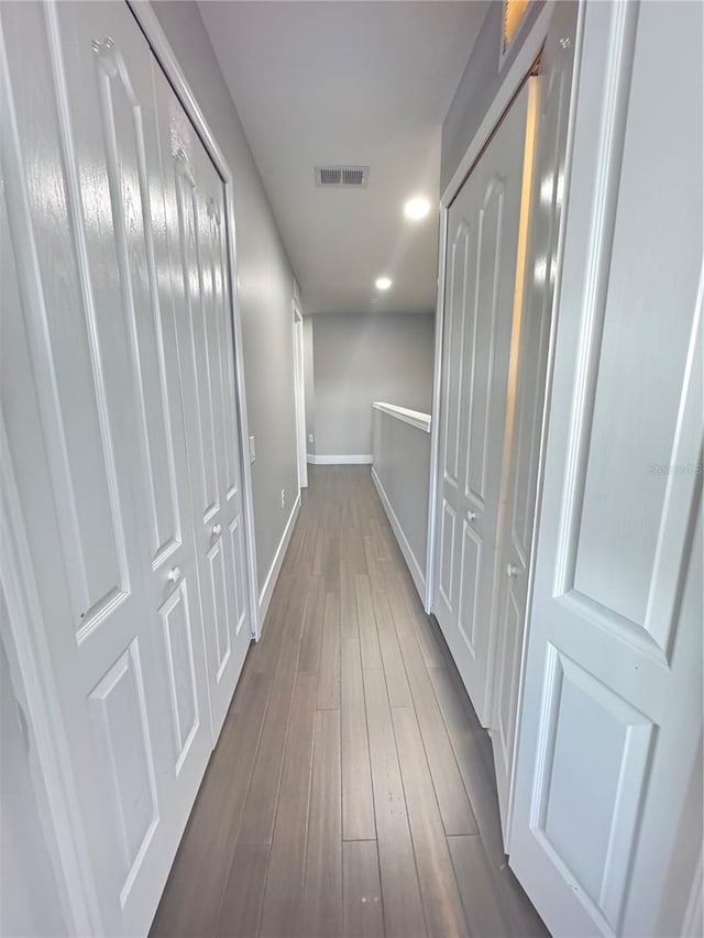 hallway with dark hardwood / wood-style floors