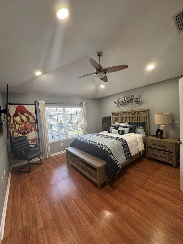 bedroom with hardwood / wood-style flooring, vaulted ceiling, and ceiling fan