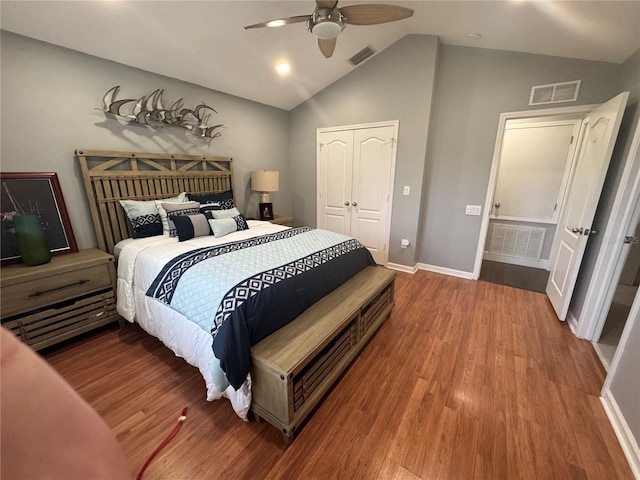 bedroom with ceiling fan, lofted ceiling, hardwood / wood-style floors, and a closet