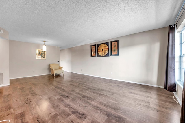 empty room featuring hardwood / wood-style flooring and a textured ceiling