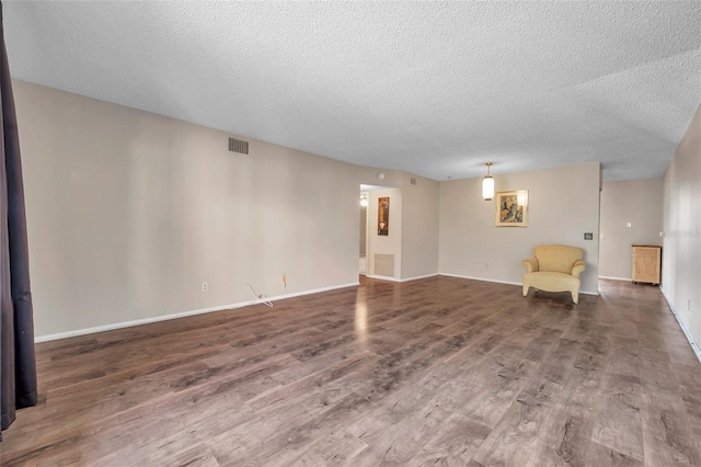 interior space with wood-type flooring and a textured ceiling