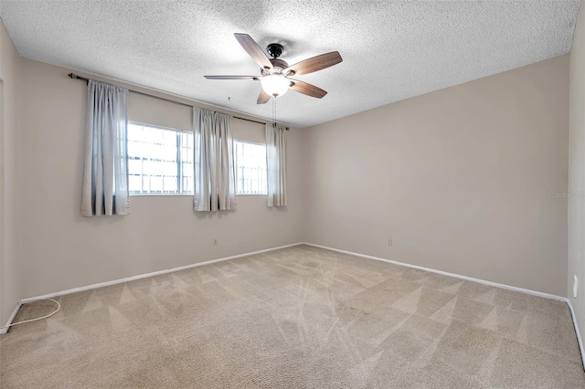 carpeted spare room featuring a textured ceiling and ceiling fan