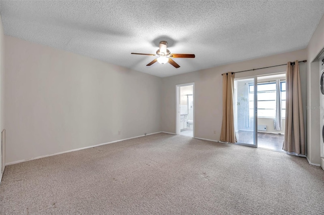 carpeted spare room with a textured ceiling and ceiling fan