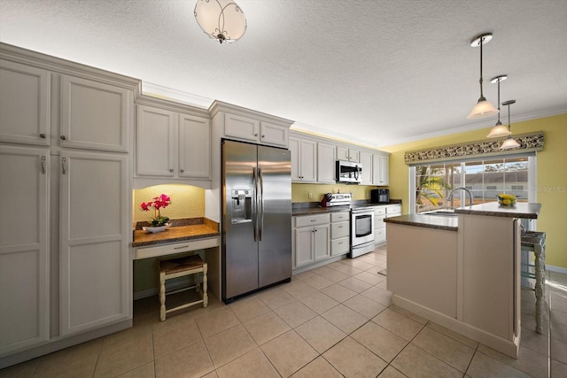 kitchen with appliances with stainless steel finishes, sink, hanging light fixtures, ornamental molding, and light tile patterned floors