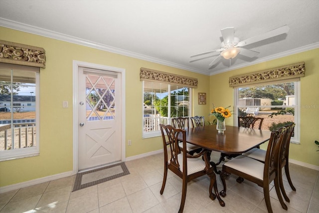 dining area with crown molding, ceiling fan, and light tile patterned floors