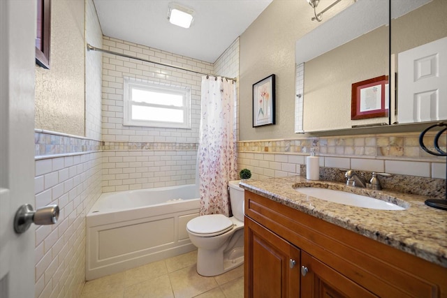 full bathroom featuring tile walls, vanity, toilet, tile patterned floors, and shower / bath combo with shower curtain