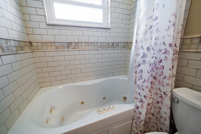 bathroom featuring shower / bath combination with curtain and toilet