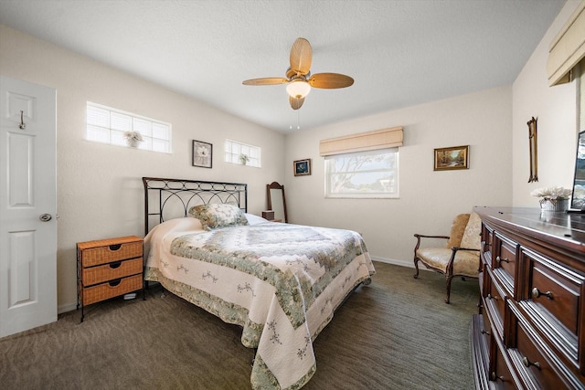 bedroom featuring ceiling fan and dark carpet