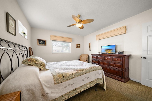 carpeted bedroom featuring a textured ceiling and ceiling fan