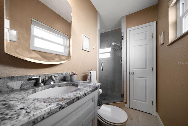 bathroom with vanity, toilet, a shower with shower door, and tile patterned flooring