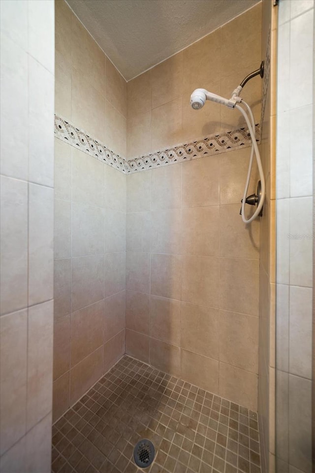 bathroom with tiled shower