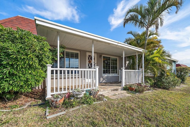 view of front of home with a front yard and covered porch