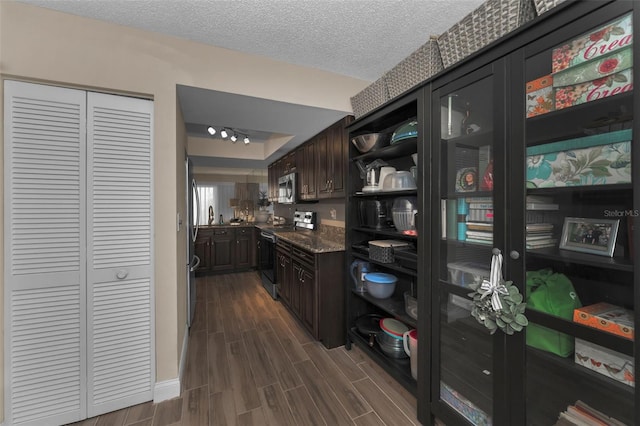 interior space with wood tiled floor and a textured ceiling