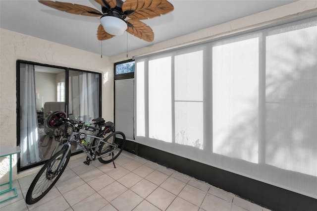 sunroom featuring a wealth of natural light and ceiling fan