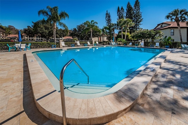 pool featuring fence and a patio