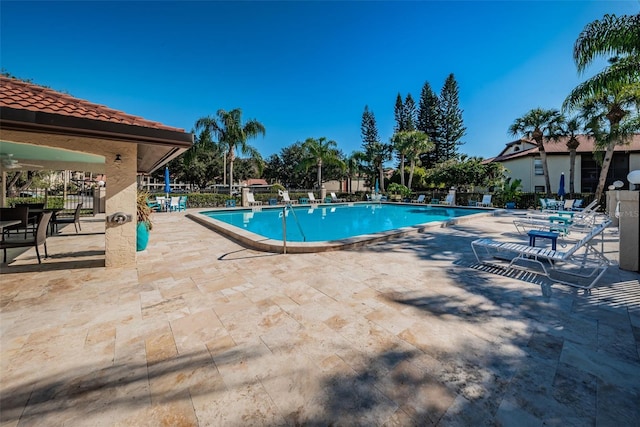 pool featuring a patio area and fence