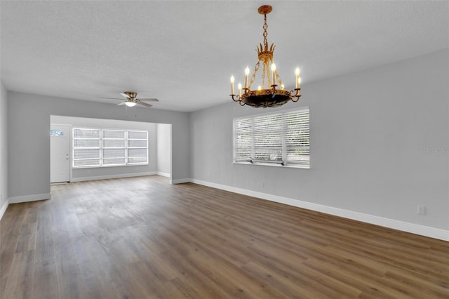 interior space featuring dark wood-type flooring, ceiling fan with notable chandelier, and a textured ceiling