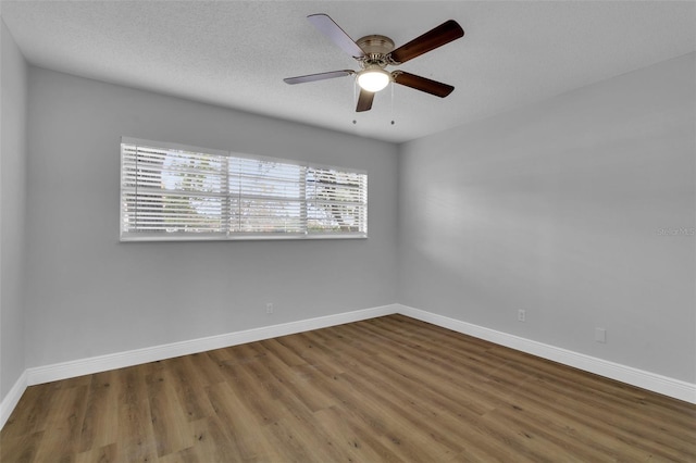 empty room with hardwood / wood-style flooring, ceiling fan, and a textured ceiling