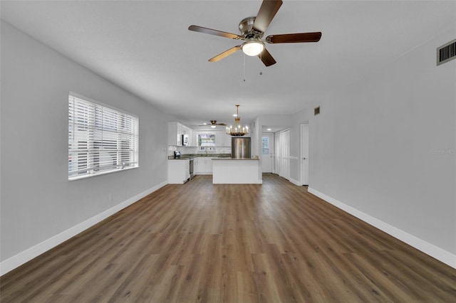 unfurnished living room featuring dark hardwood / wood-style floors and ceiling fan