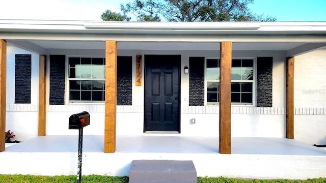 view of exterior entry featuring a porch