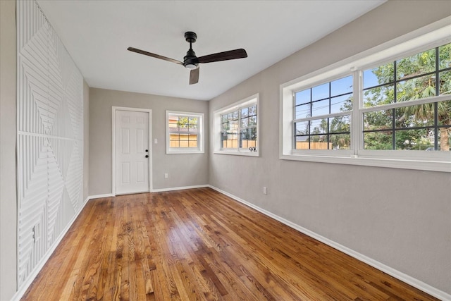 unfurnished room featuring hardwood / wood-style floors and ceiling fan