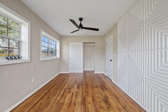 unfurnished bedroom featuring wood-type flooring and ceiling fan