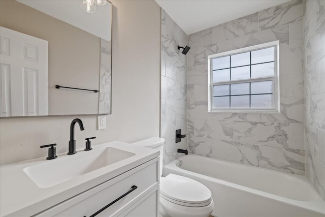 full bathroom featuring vanity, tiled shower / bath combo, and toilet