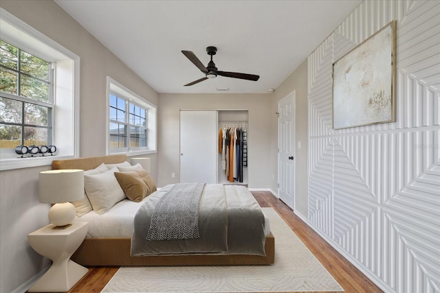 bedroom featuring hardwood / wood-style flooring and ceiling fan