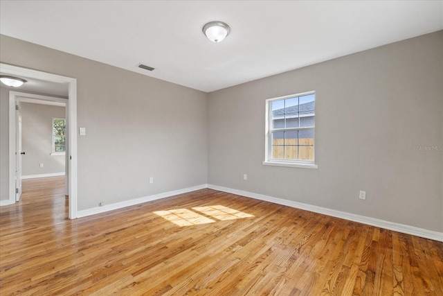 spare room with a healthy amount of sunlight and light wood-type flooring