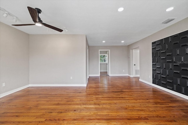 spare room with hardwood / wood-style floors and ceiling fan