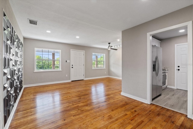 interior space with ceiling fan and light hardwood / wood-style floors