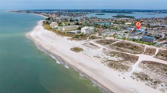 birds eye view of property featuring a water view and a beach view