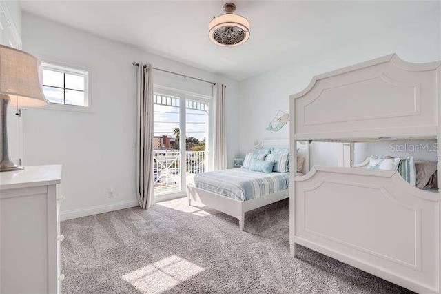 carpeted bedroom featuring multiple windows, access to exterior, and ceiling fan