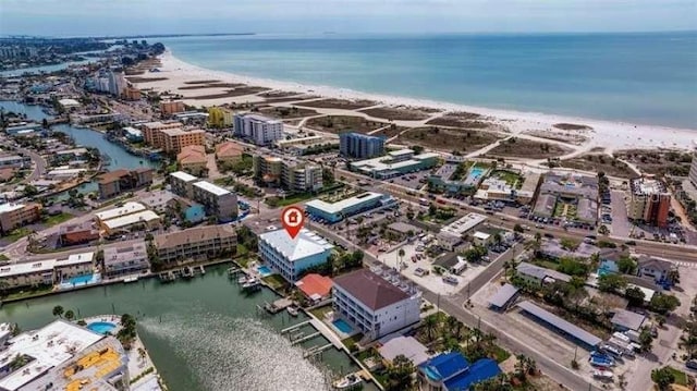 birds eye view of property with a beach view and a water view