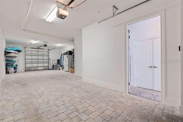 garage with baseboards and a garage door opener