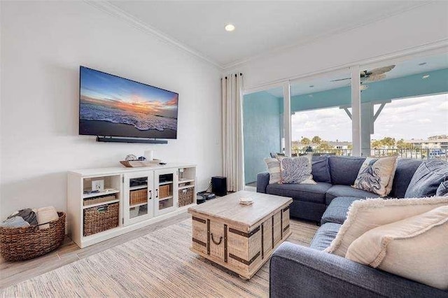 living area with crown molding and light wood finished floors