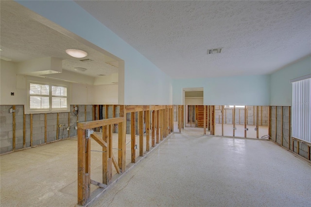 corridor featuring a textured ceiling