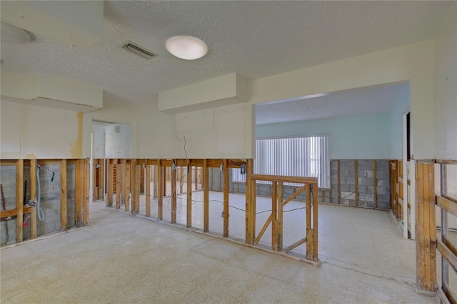 unfurnished room featuring a textured ceiling