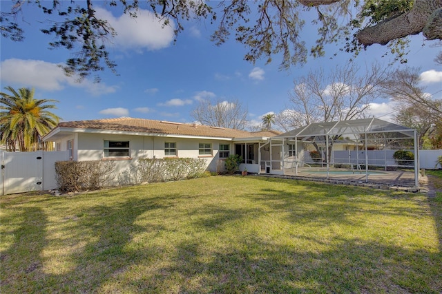 back of house with a yard, a lanai, and a patio area