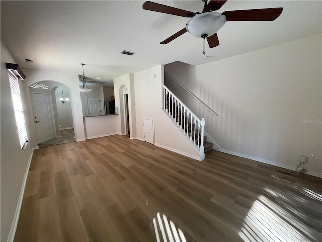 unfurnished living room with ceiling fan and dark hardwood / wood-style floors