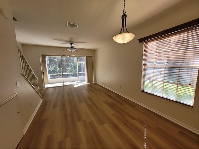 unfurnished room featuring dark hardwood / wood-style floors and ceiling fan