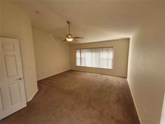 carpeted empty room featuring vaulted ceiling and ceiling fan