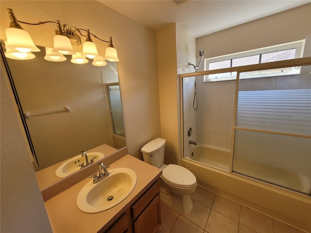 full bathroom with vanity, tile patterned floors, shower / bath combination with glass door, and toilet