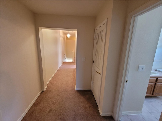 hall with light colored carpet