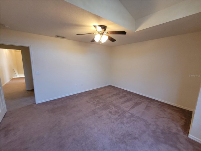 unfurnished room with dark carpet and ceiling fan