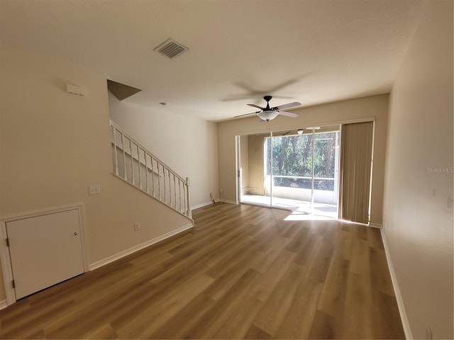 unfurnished living room featuring hardwood / wood-style floors and ceiling fan