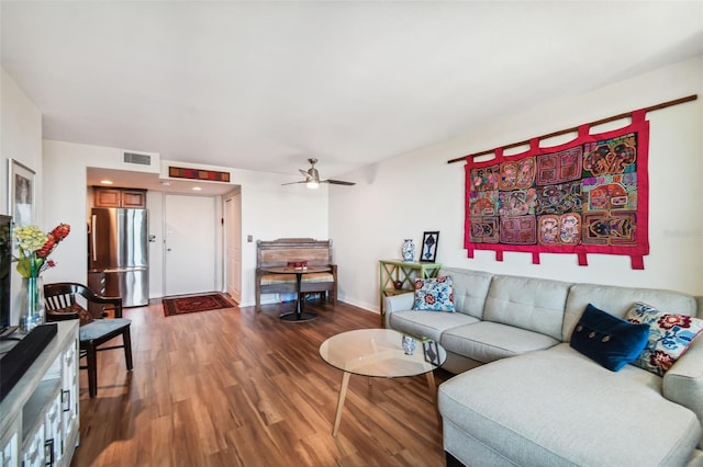 living room featuring wood-type flooring and ceiling fan