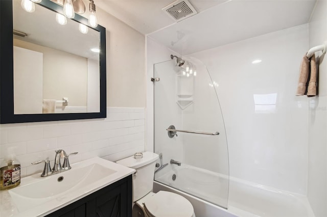 full bathroom featuring vanity, tile walls, toilet, and combined bath / shower with glass door