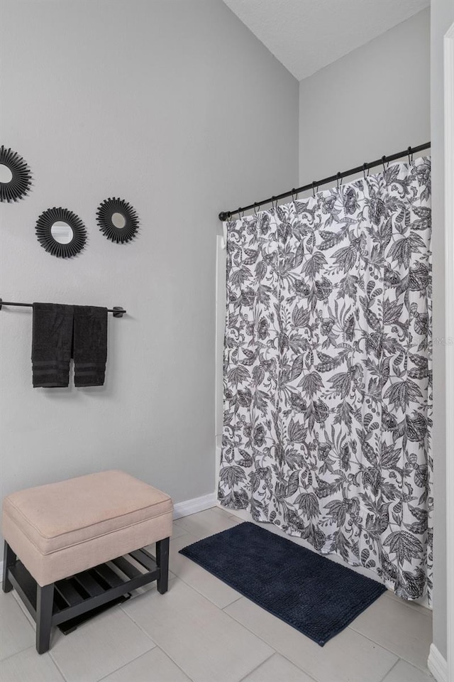 bathroom featuring tile patterned floors and a shower with curtain