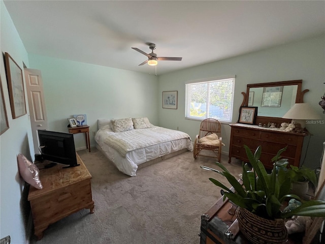 bedroom featuring light carpet and ceiling fan